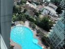 Aerial view of a residential complex with a large swimming pool