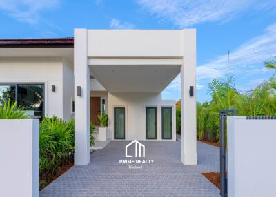 Front view of a modern residential building with entrance and landscaping