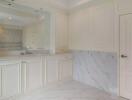 Bright white kitchen with marble accents