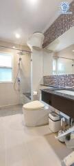 Modern bathroom with tiled walls and mirror