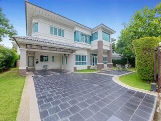 Exterior view of a modern two-story house with driveway and garden