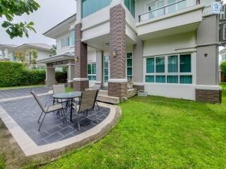 Outdoor seating area in front of a modern house