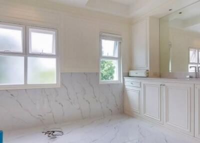 Spacious bathroom with large windows and white marble finishes