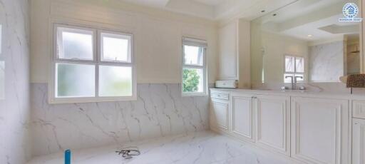 Spacious bathroom with large windows and white marble finishes