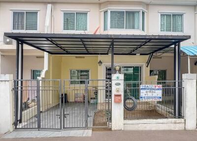 Front view of townhouse with gated parking area