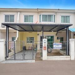 Front view of townhouse with gated parking area