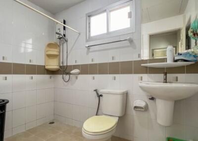 Well-lit bathroom with modern amenities