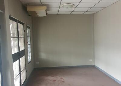 Empty room with windows and ceiling tiles