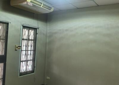 Empty bedroom with air conditioner and window