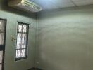 Empty bedroom with air conditioner and window