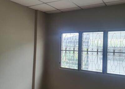 Empty bedroom with window and tiled ceiling