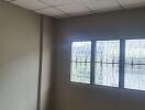 Empty bedroom with window and tiled ceiling