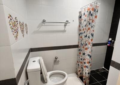 Modern bathroom with white fixtures and decorative tiles