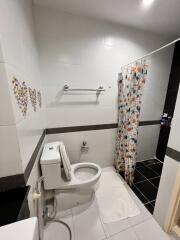 Modern bathroom with white fixtures and decorative tiles