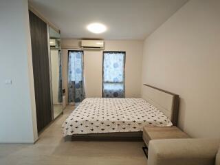 Modern bedroom with a bed, wardrobe, and air conditioning.