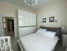 Bedroom with a double bed, wardrobe, and modern lighting