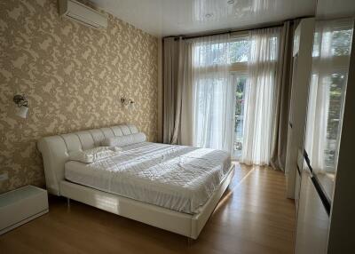 Spacious bedroom with large bed and window