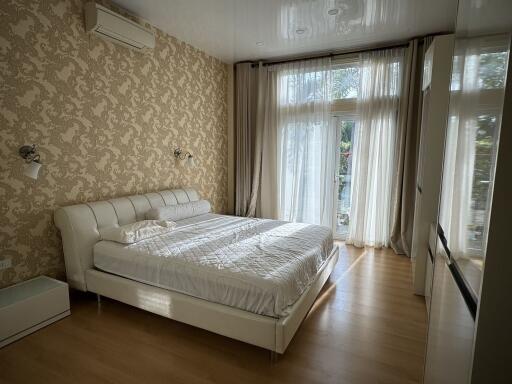 Spacious bedroom with large bed and window