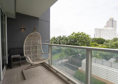 Spacious balcony with hanging chair and view of the city