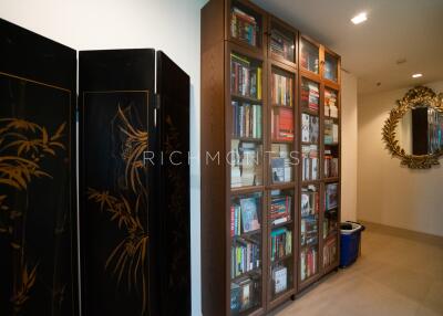 Hallway with bookcase and decorative mirror