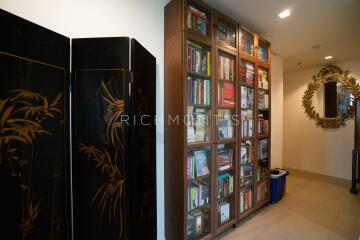 Hallway with bookcase and decorative mirror