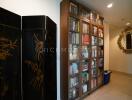 Hallway with bookcase and decorative mirror