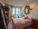 Cozy bedroom with a bed, ornate mirror, and a window with curtains.