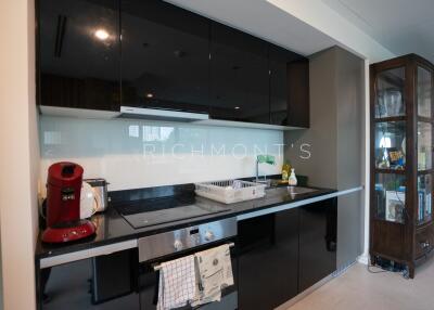 Modern kitchen with sleek black cabinets and appliances