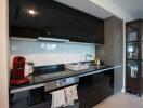 Modern kitchen with sleek black cabinets and appliances