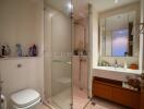 Modern bathroom with glass shower enclosure and wooden vanity