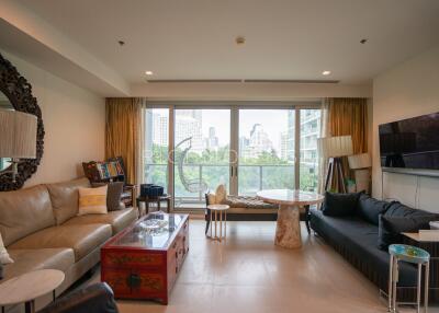 Living room with large windows, sofas, and a city view