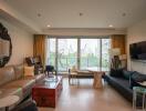 Living room with large windows, sofas, and a city view