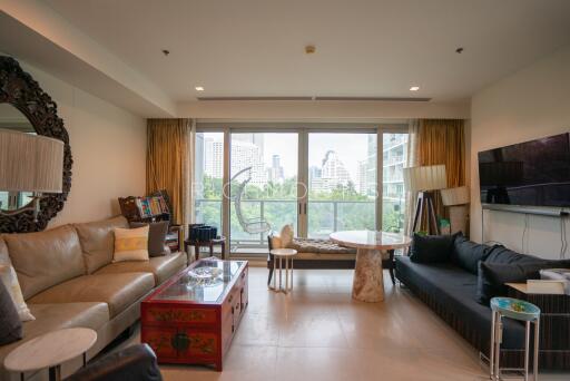 Living room with large windows, sofas, and a city view