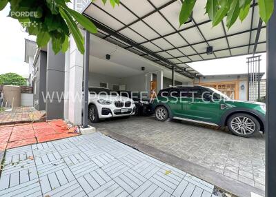 Covered garage with several parked cars