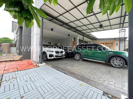 Covered garage with several parked cars