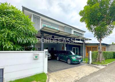 Front view of a modern house with a garage and greenery