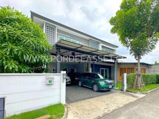 Front view of a modern house with a garage and greenery