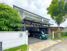 Front view of a modern house with a garage and greenery