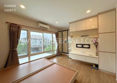 Modern living room with built-in storage and large windows