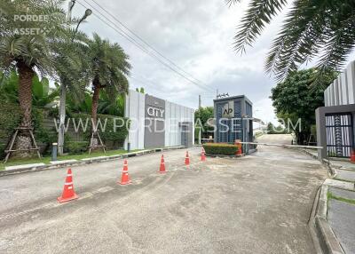 Gated community entrance with security gate and traffic cones