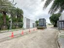 Gated community entrance with security gate and traffic cones