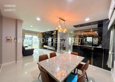 Modern dining area with marble table and stylish lighting