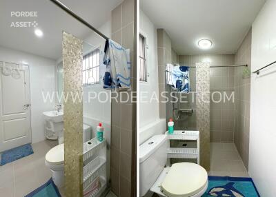 Modern bathroom with shower, toilet, sink, and storage unit