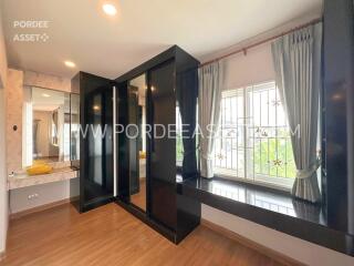 Bedroom with mirrored wardrobe and large window