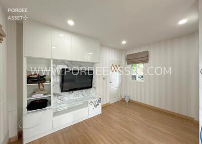 modern living room with hardwood floor and wall-mounted TV