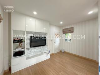 modern living room with hardwood floor and wall-mounted TV