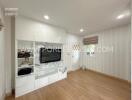 modern living room with hardwood floor and wall-mounted TV