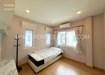 Bedroom with bed, air conditioner, and window