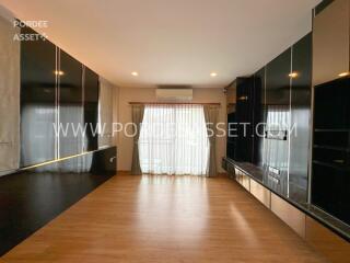 Spacious living room with wooden flooring and large window