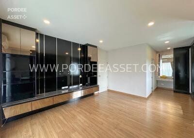 Spacious living room with wooden flooring and built-in storage